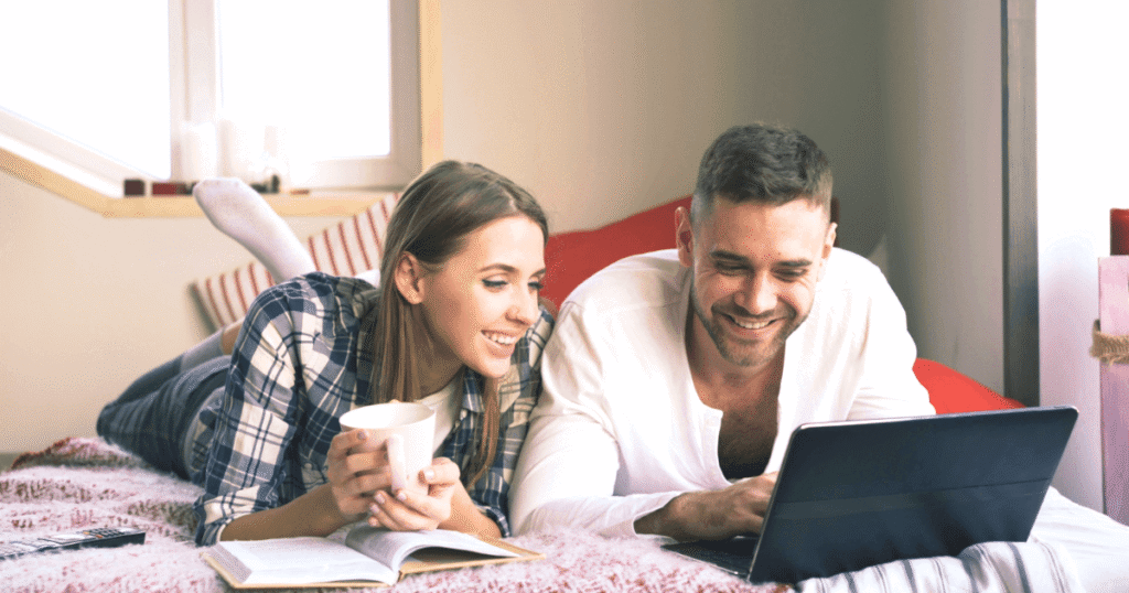 Couple reviewing I-485 checklist documents together on a laptop